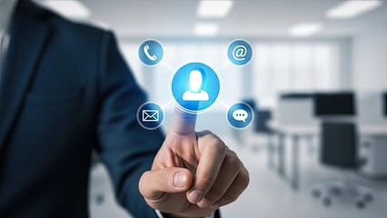 Businessman touching virtual contact icon in a modern office setting.