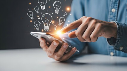 Mans hand using smartphone with light bulb icons for creative idea generation.