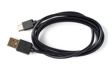 Black USB to USB type-c cable on a white background. Close-up of a coil of cable