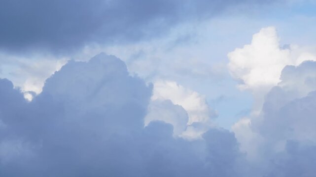 Soft evolving clouds moving across a blue sky. Natural atmospheric cloud movement ideal for transitions, backgrounds, and sky textures in video editing and motion graphics.