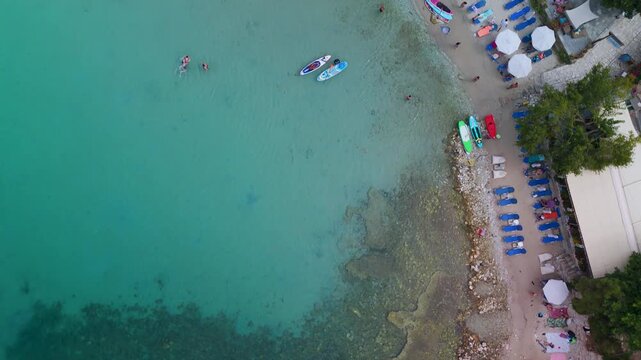 Vertical Top-Down Aerial Drone Shot High Above the Turquoise Coves and Sandy Beaches of Alyki Peninsula, Thasos Island, Greece, Meeting the Clear Aegean Sea.