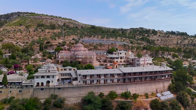 Aerial Drone Shot Approaching the Holy Monastery of the Archangel Michael Perched on a Cliff Above the Aegean Sea, Thasos Island, Greece.