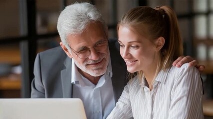 Shared Focus: Two individuals, a mentor and mentee, working together and focused on a laptop screen, creating a sense of camaraderie and shared purpose.