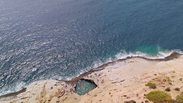 Vertical Aerial Drone Shot Descending Over the Turquoise Waters of Giola Lagoon, also known as Aphrodite's Tear, on the Thasos Coastline, Greece.