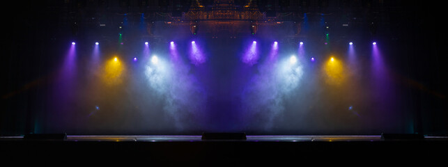 The stage of the theater illuminated by spotlights from the auditorium
