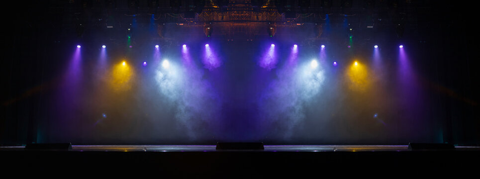 The stage of the theater illuminated by spotlights from the auditorium