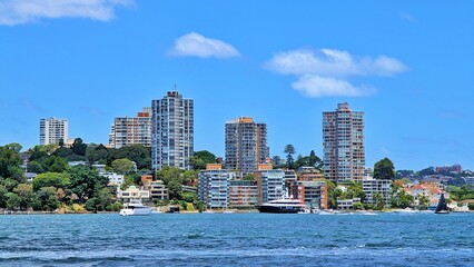 Point Piper, situated on Sydney Harbour, features tall residential buildings surrounded by lush greenery.