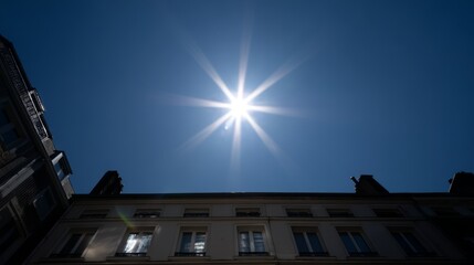 Intense Solar Radiation and Peak Sunlight Above Urban Building in Clear Blue Sky