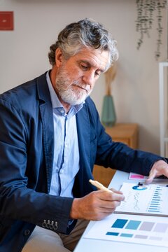 Businessman developing strategy and analyzing data at office desk