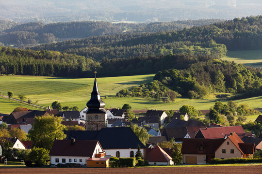 Village with church and fields in Franconian Switzerland Bavaria Germany