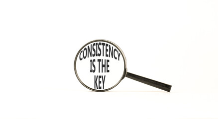 Consistency is the key symbol. Concept words Consistency is the key on beautiful magnifying glass. Beautiful white background. Business consistency is the key concept. Copy space.