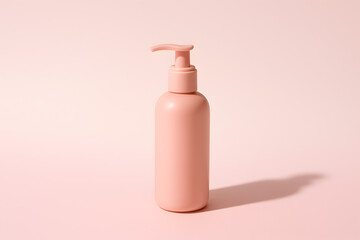 Pink bottle with pump dispenser on pastel background