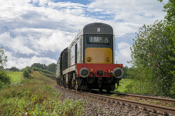 Obraz premium Vintage British Class 20 Diesel Locomotive in Summer Countryside