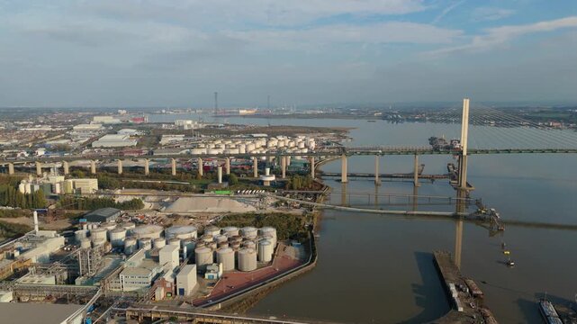 Aerial Drone View of Industrial Port Infrastructure Along River Thames With Queen Elizabeth Bridge and Dartford Tunnel During Sunset in London UK