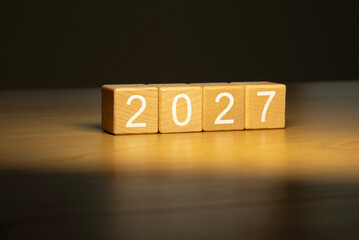 Craft wooden cube blocks 2027. Numbers on wooden blocks with copy space. 2027 happy new year idea concept.