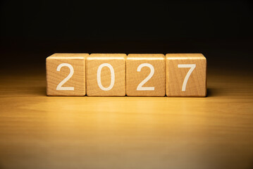 Craft wooden cube blocks 2027. Numbers on wooden blocks with copy space. 2027 happy new year idea concept.