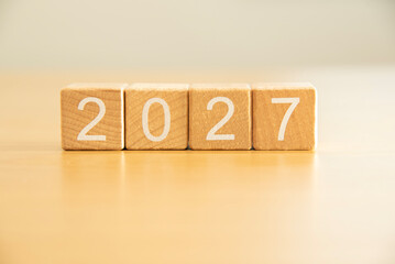 Craft wooden cube blocks 2027. Numbers on wooden blocks with copy space. 2027 happy new year idea concept.