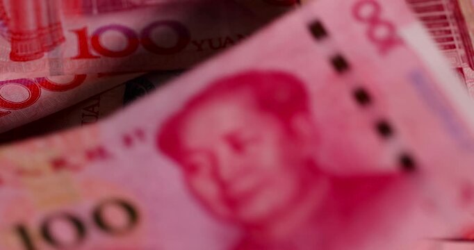 dollars and red Chinese cash in denominations of one hundred yuan and American dollars , a pile of paper cash of American and Chinese money , Chinese banknotes of 100 yuan