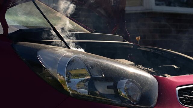 Broken down car with smoke coming out of engine