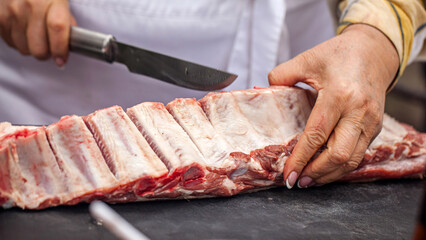 Butcher Preparing Raw Pork Ribs