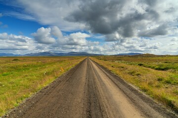Fototapeta premium dirt and gravel Highway number 540 leading to the distant hamlet of Akrar on the coast of Western iceland near Borgarnes