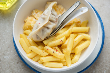Garaetteok or korean traditional snack served with steamed egg and dumpling in a white bowl, middle close-up, horizontal shot