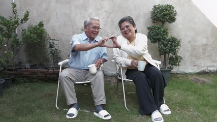 Couple enjoys time together in garden with laughter and joyful moments