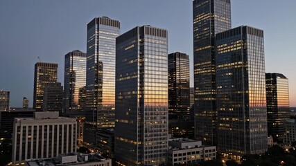 Urban skyline at dusk with skyscrapers reflecting sunset in metropolitan city - Powered by Adobe
