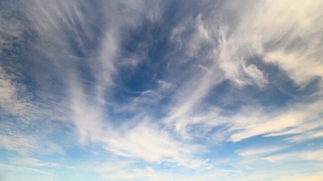 Tranquil atmospheric scene featuring flowing cirrus formations at dusk, Serene sky view during sunset highlighting fragile highaltitude clouds drifting gracefully