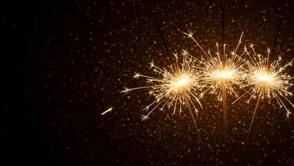 Fototapeta premium Sparkling celebration: Golden sparklers ablaze against a dark, textured backdrop creating holiday