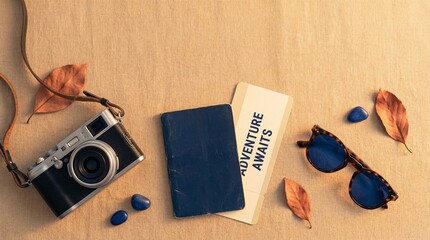 Camera, travel journal, and sunglasses on wooden table with leaves  