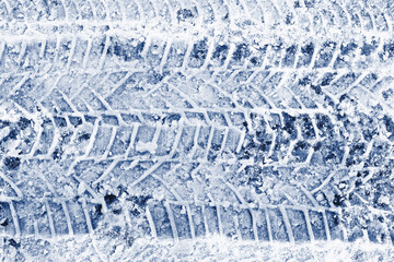Snow tire tracks texture. Icy winter road surface. Frozen pattern background. Cold season detail view. Vehicle trace on snow. Slippery ice abstract backdrop. Rough winter texture. Cold weather frost.