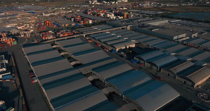 Aerial shot of warehouses at Luka Koper port, Slovenia. Shows industrial buildings, storage facilities, and port infrastructure from above, highlighting logistics and maritime operations.