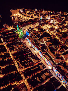 Aerial view of the illuminated Stradun and the Old Port sparkle with golden light amidst the historic architecture, Dubrovnik, Dubrovnik-Neretva County, Croatia.