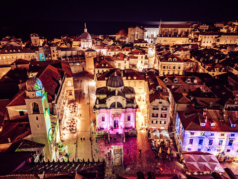 Aerial view of a captivating scene where the illuminated Cathedral and Rector's Palace meet the night in a dance of light, Dubrovnik, Dubrovnik-Neretva County, Croatia.