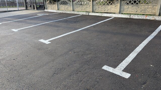 Concrete Parking Area, An Empty Roadway Surface With Aligned Parking Zones And Subdued Morning Light