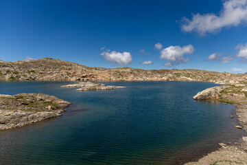 Fototapeta premium Scenic Lac de la Fare in the Grandes Rousses massif, French Alps, surrounded by mountains and alpine nature