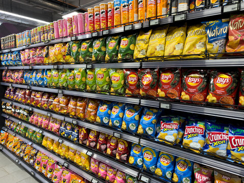 Moscow, Russia, December 28, 2025: Huge selection of Lays chips. Store shelves are filled with fried potato snacks. Lay's News. Delicious chips with flavor for every taste