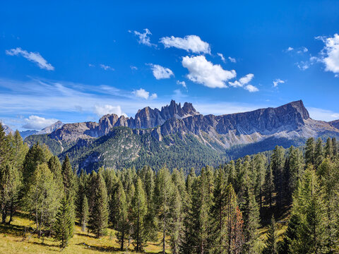 Scenic mountain view with rugged peaks and green forest. Clear weather and idyllic alpine landscape. Croda da Lago, Dolomites, Italy