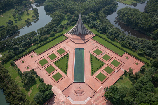 Aerial view of the National Martyrs' Memorial with its triangular structures and reflecting pool surrounded by lush greenery, Savar, Dhaka Division, Bangladesh.