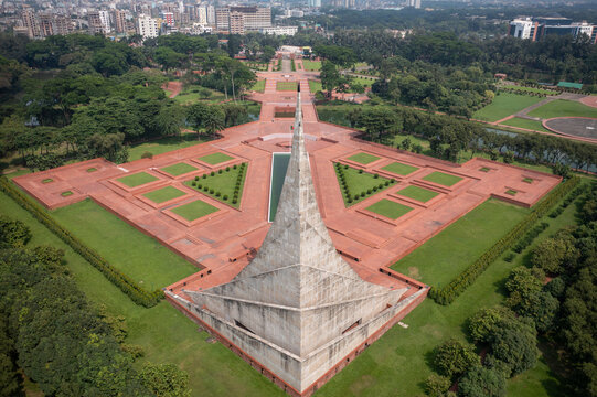Aerial view of the National Martyrs' Memorial, a striking monument with geometric shapes surrounded by lush greenery, Savar, Dhaka Division, Bangladesh.