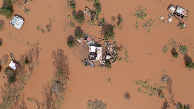 Aerial view of floodwaters engulfing homes and structures, leaving a trail of destruction across the landscape, Buzi, Sofala Province, Mozambique.