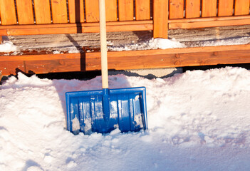 blue shovel for cleaning snow in a snowdrift