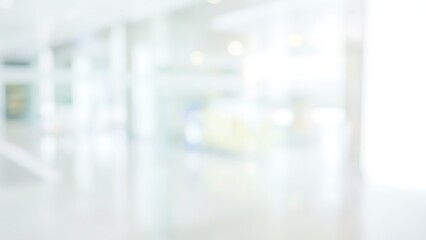 Blurred modern office lobby with glass walls and bright daylight