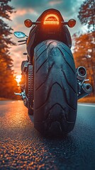 Motorcycle Rear View with Glowing Tail Lights at Sunset tire photo