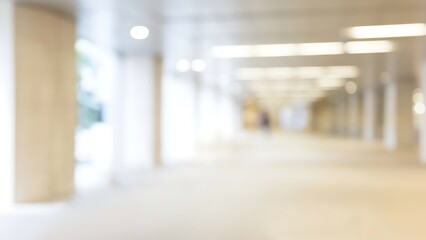 Fototapeta premium Blurred interior corridor with columns and bright linear lighting in a modern building