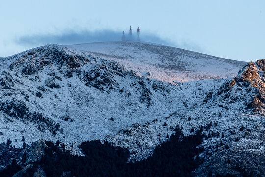 Sunrise at the Navacerrada reservoir with the Sierra de Guadarrama mountains covered in snow