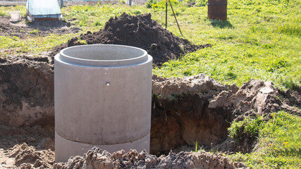 Well concrete with a ring for a well dug by an excavator