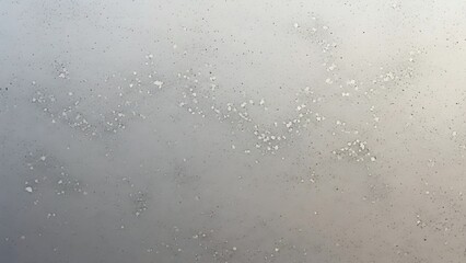 Obraz premium A serene winter landscape with frosty mist and snowflakes gently falling on a frosted glass surface viewed from a close-up perspective