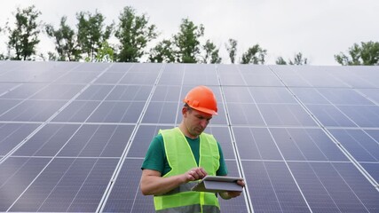 Engineer configure and monitor solar panel performance on a tablet demonstrating renewable energy technology clean electricity and independent power solutions. High quality 4k footage - Powered by Adobe